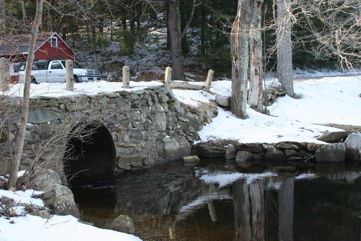 Winter scene of a stone bridge of Lower Spectacle Pond