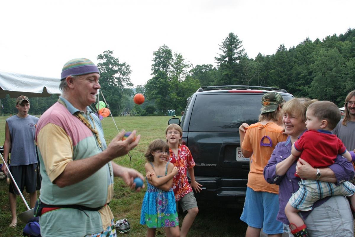Man juggling with children at the 250th Anniversary Fair in Sandisfield
