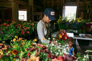 Woman selecting flowers at Snow Farm in Sandisfield 